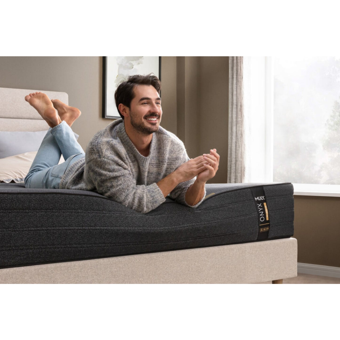 ONYX 12" Hybrid Mattress With Copper Infused Memory Foam Inside Of A Bedroom With A Man Lying On His Stomach