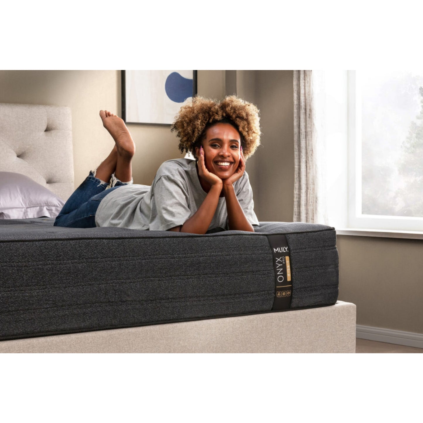 ONYX Pro 13" Hybrid Mattress With Copper Infused Memory Foam Inside Of A Bedroom With A Woman Lying On Her Stomach