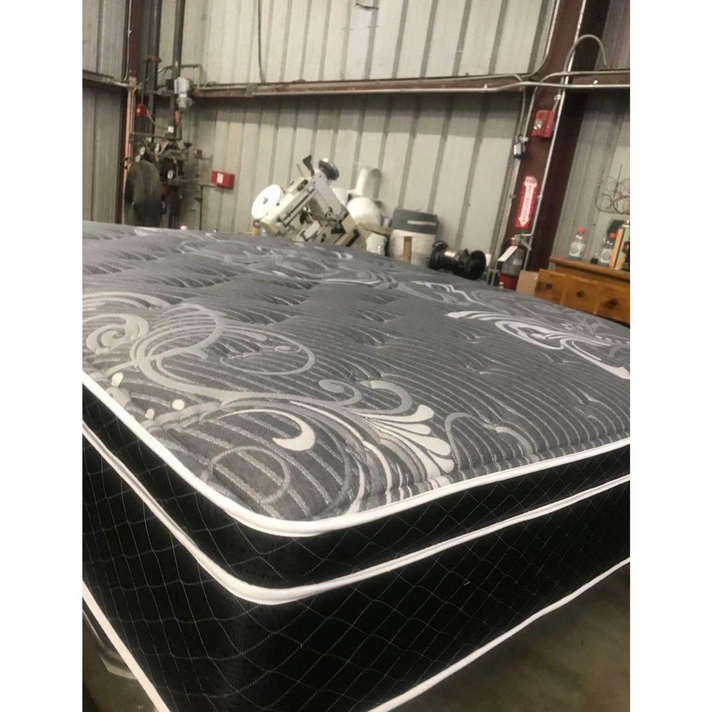 Vivians 13" Innerspring Mattress With Black Quilt, Inside Of A Warehouse, Corner View, Zoomed In