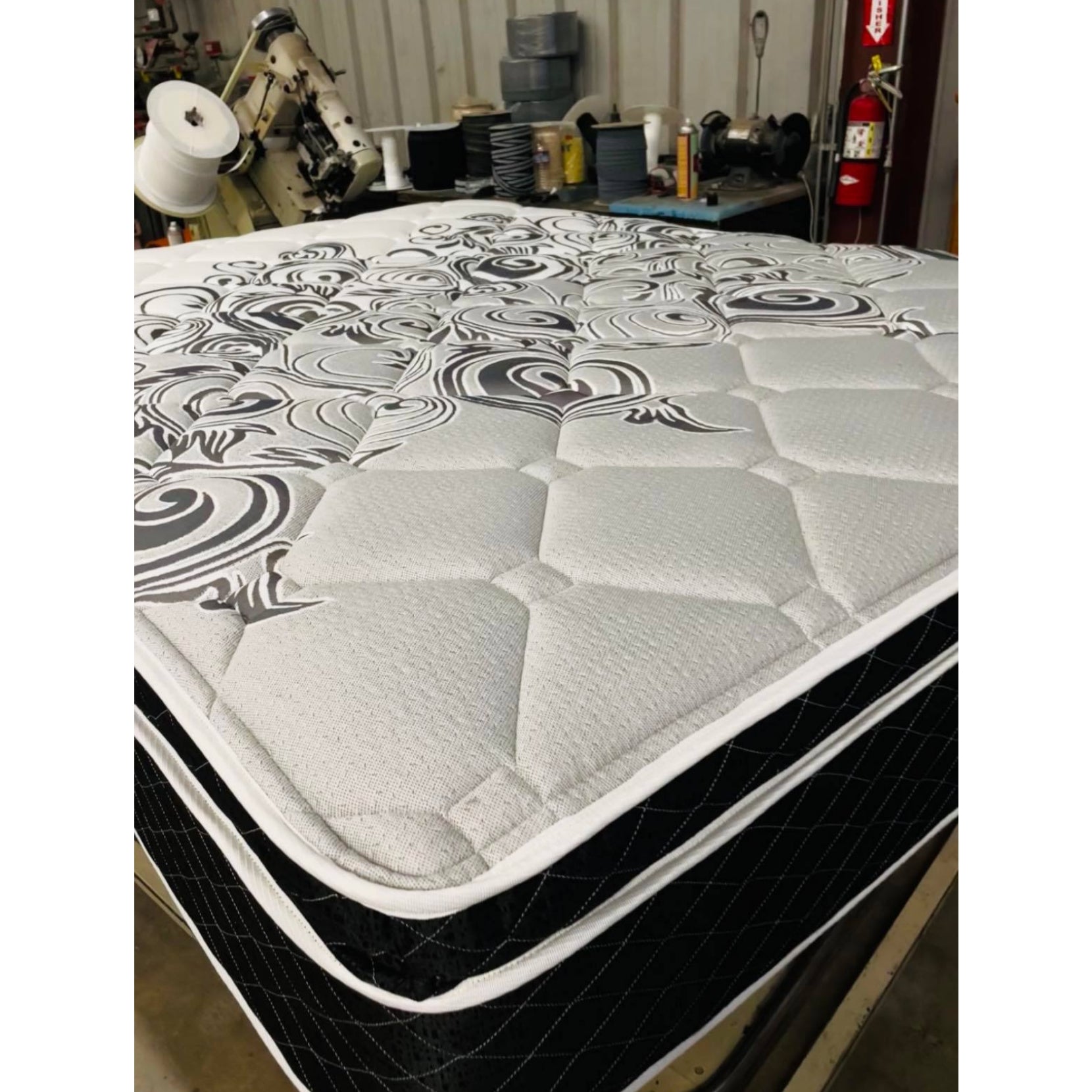 Vivians 13" Innerspring Mattress With Gray Quilt, Inside Of A Warehouse, Corner View, Zoomed In